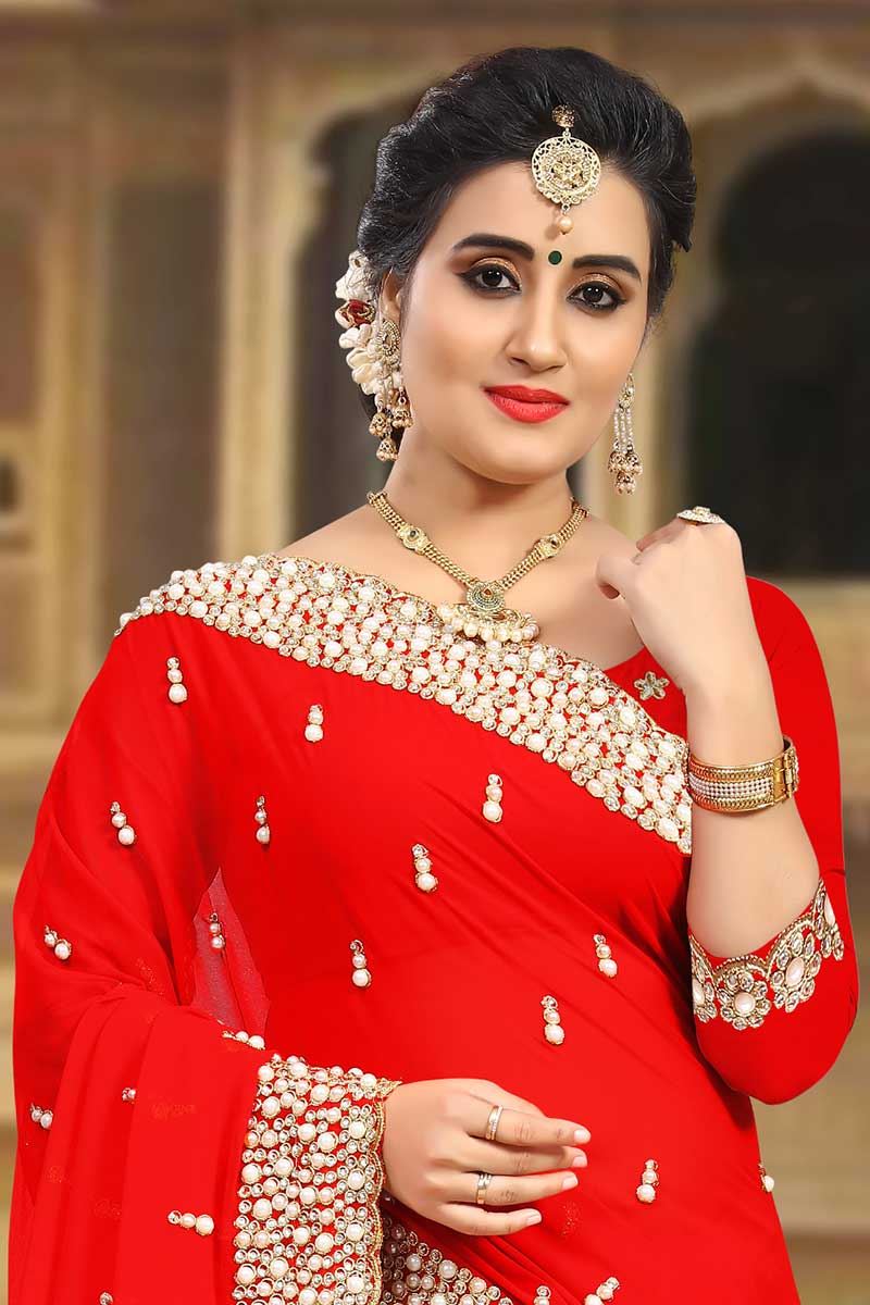 Striking red designer saree with motifs